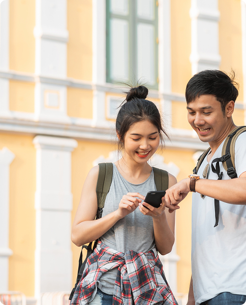 Two students looking at a phone screen together, learning about the app.