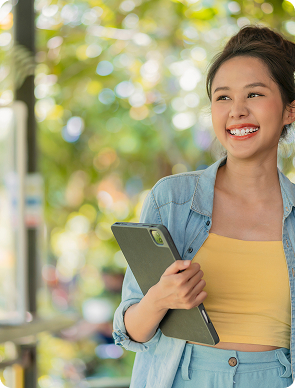 Smiling college student holding a tablet